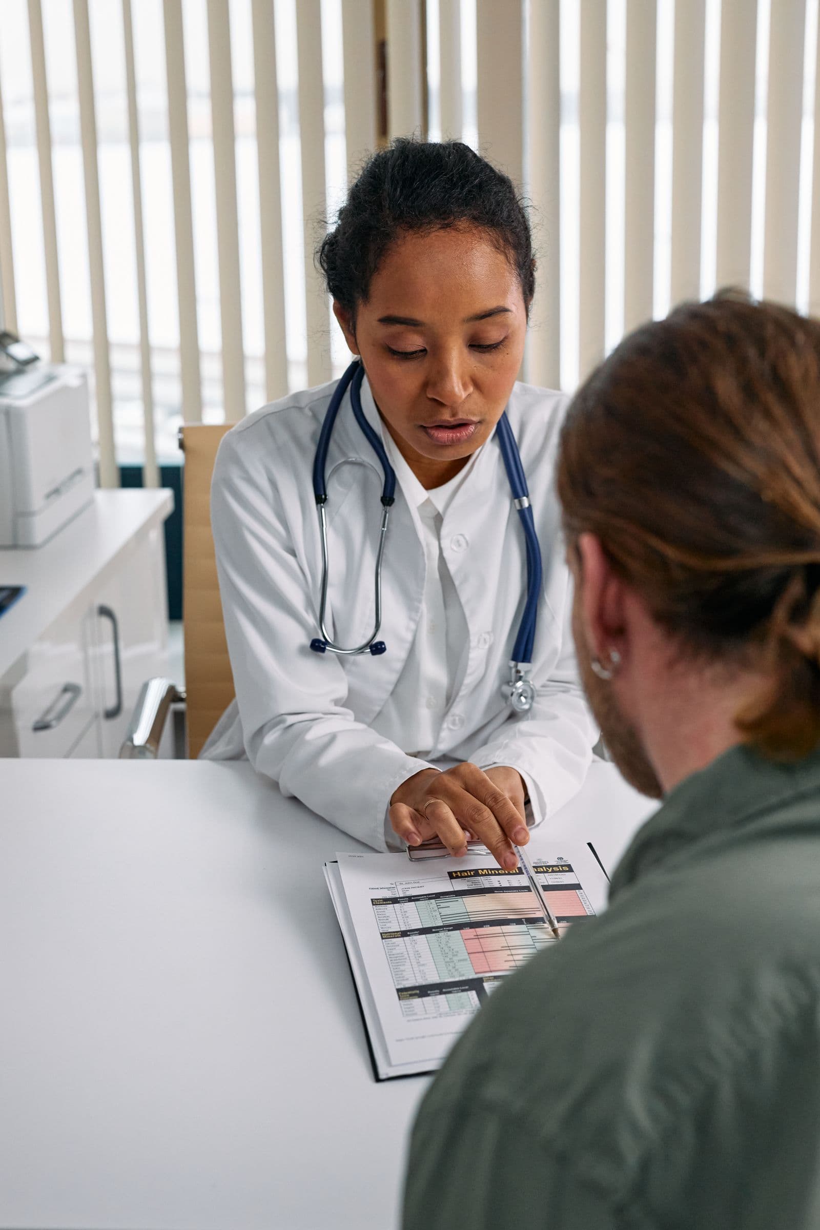 A friendly doctor reviewing a health plan chart