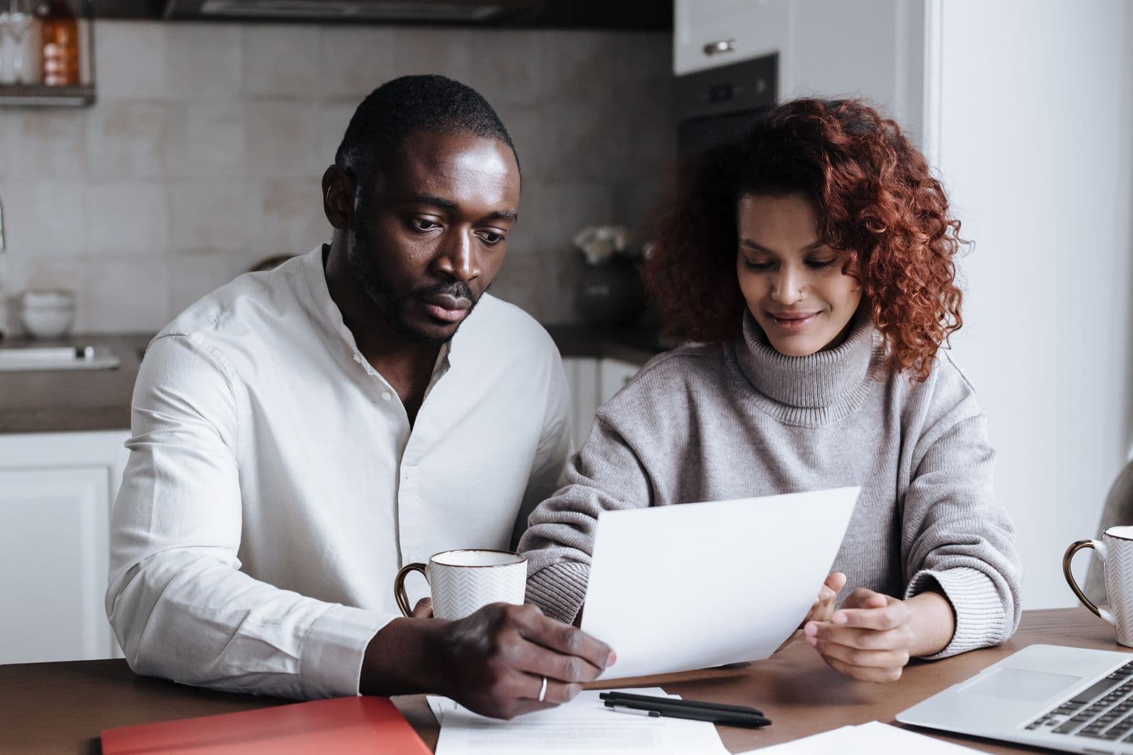 A couple reviewing their coverage paperwork at the kitchen table